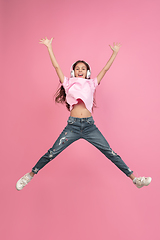 Image showing Caucasian little girl portrait isolated on pink studio background, emotions concept