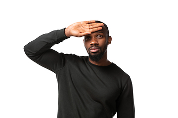 Image showing How coronavirus changed our lives. Young man taking temperature on white background