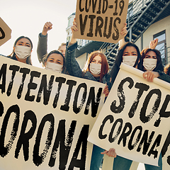 Image showing Young people in face masks protesting of stop coronavirus pandemic on the street