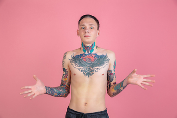 Image showing Portrait of young man with freaky appearance on pink background