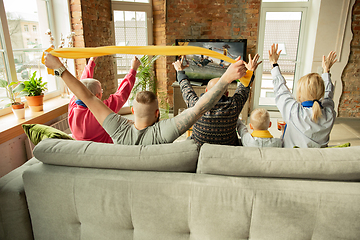 Image showing Excited family watching female football, sport match at home