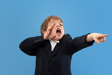 Image showing Portrait of a young orthodox jewish boy isolated on blue studio background, meeting the Passover