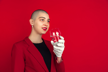 Image showing Portrait of young caucasian bald woman on red background