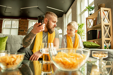 Image showing Excited family watching football, sport match at home, father and son