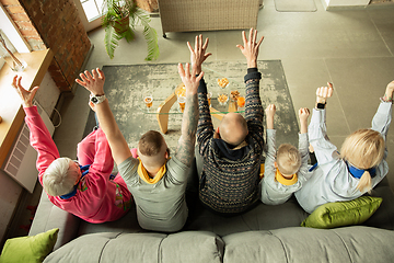 Image showing Excited family watching football, sport match at home, top view