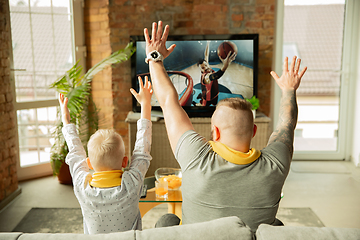 Image showing Excited family watching basketball, sport match at home, father and son