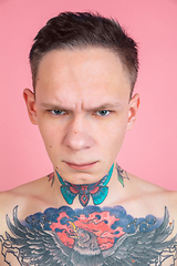Image showing Portrait of young man with freaky appearance on pink background