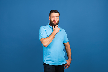 Image showing Caucasian man\'s portrait isolated on blue studio background with copyspace