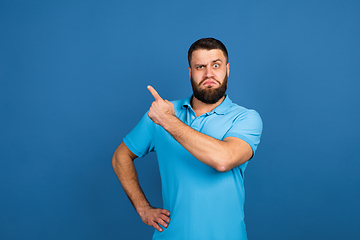 Image showing Caucasian man\'s portrait isolated on blue studio background with copyspace