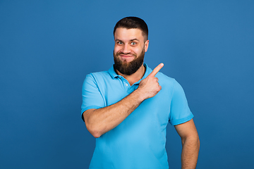 Image showing Caucasian man\'s portrait isolated on blue studio background with copyspace