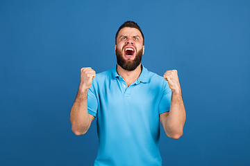 Image showing Caucasian man\'s portrait isolated on blue studio background with copyspace