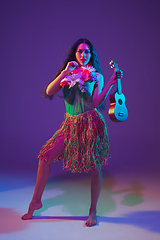 Image showing Fabulous Cinco de Mayo female dancer on purple studio background in neon light