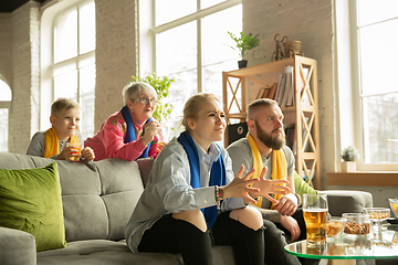 Image showing Excited family watching football, sport match at home, top view