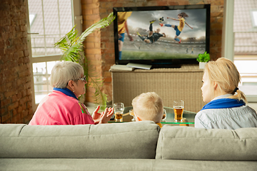 Image showing Excited family watching football, sport match at home, grandma, mother and son