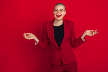 Image showing Portrait of young caucasian bald woman on red background