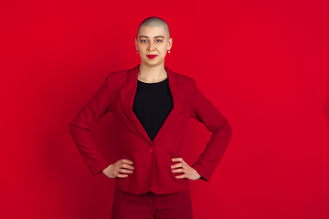 Image showing Portrait of young caucasian bald woman on red background