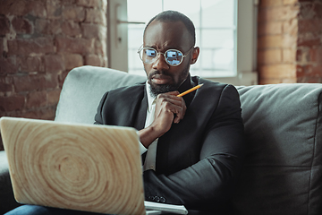 Image showing Businessman or student working from home while being isolated or keep quarantine \'cause of coronavirus COVID-19