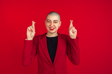 Image showing Portrait of young caucasian bald woman on red background