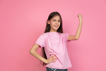 Image showing Caucasian little girl portrait isolated on pink studio background, emotions concept