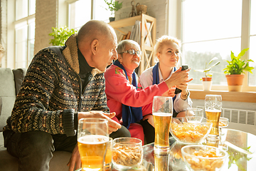 Image showing Excited family watching football, sport match at home, top view