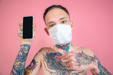 Image showing Portrait of young man with freaky appearance on pink background