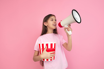 Image showing Caucasian little girl portrait isolated on pink studio background, emotions concept