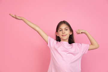 Image showing Caucasian little girl portrait isolated on pink studio background, emotions concept