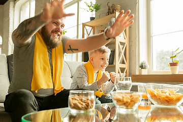 Image showing Excited family watching football, sport match at home, father and son