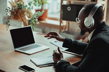 Image showing Businessman or student working from home while being isolated or keep quarantine \'cause of coronavirus COVID-19