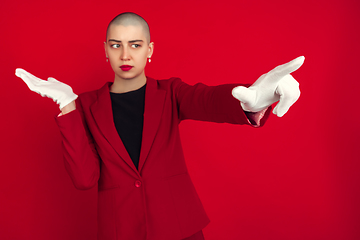 Image showing Portrait of young caucasian bald woman on red background