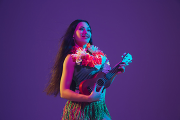 Image showing Fabulous Cinco de Mayo female dancer on purple studio background in neon light