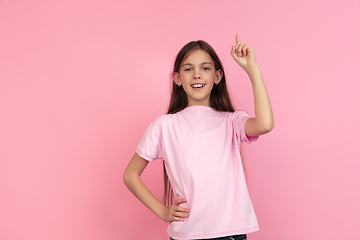 Image showing Caucasian little girl portrait isolated on pink studio background, emotions concept