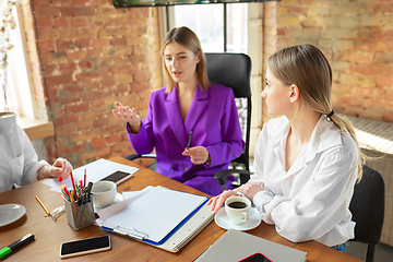 Image showing Business young caucasian woman in modern office with team