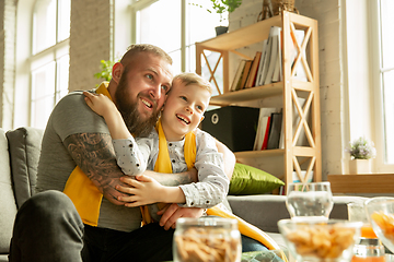 Image showing Excited family watching football, sport match at home, father and son