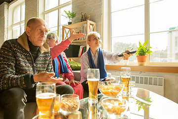 Image showing Excited family watching football, sport match at home, top view