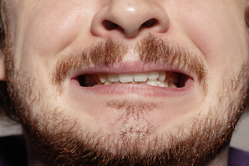 Image showing Close-up male mouth illustrating emotions. Cosmetology, dentistry and beauty care, facial expression