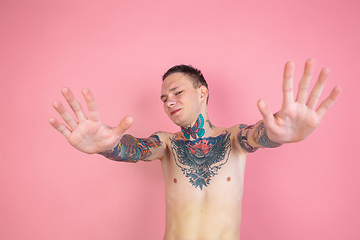 Image showing Portrait of young man with freaky appearance on pink background