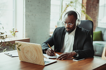 Image showing Businessman or student working from home while being isolated or keep quarantine \'cause of coronavirus COVID-19