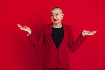 Image showing Portrait of young caucasian bald woman on red background