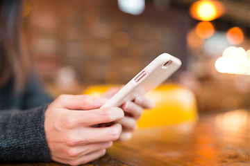 Image showing Woman sending sms on cellphone