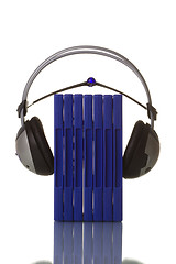 Image showing headphones holding blue dvd cases 