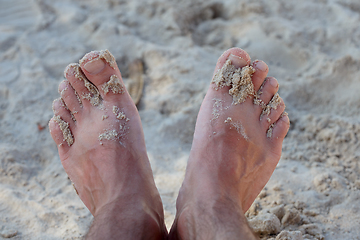 Image showing mans feet on sand beach