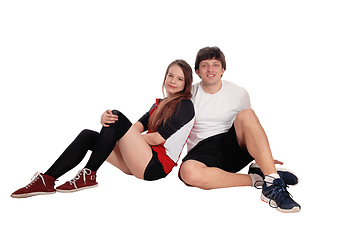 Image showing Couple sitting in sportswear on the floor