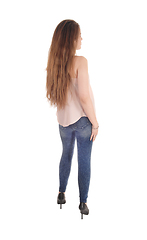 Image showing Slim woman in jeans standing from back