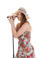 Image showing Woman standing holding microphone