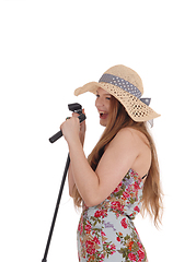 Image showing Lovely woman singing in the microphone