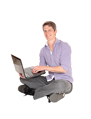 Image showing Man working on laptop on the floor