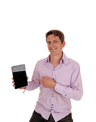 Image showing Young man pointing at his tablet screen