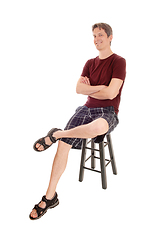 Image showing Happy man sitting on a chair smiling