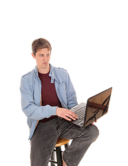 Image showing Suspicion man looking at the screen of his laptop